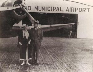 Couple in front of Orlando Municipal Airport Hangar
