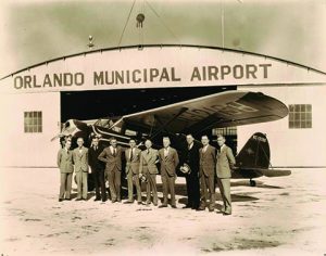 Group in front of Orlando Municipal Airport Hangar